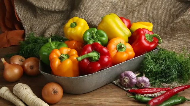 Red, green and yellow sweet bell peppers on table,