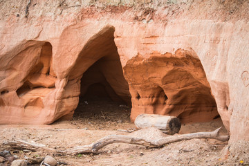 A beautiful seaside landscape with a sandstone caves. Orange sandstone shore at the Baltic sea. Landscape with caves.