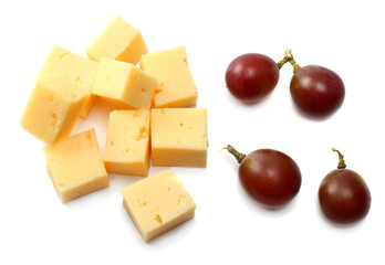 piece of cheese with grapes isolated on white background
