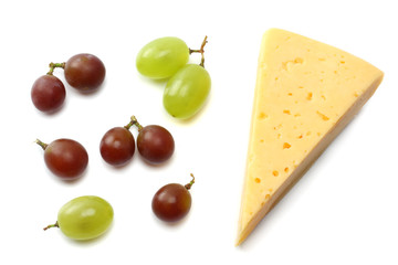 piece of cheese with grapes isolated on white background