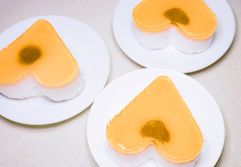 jelly heart-shaped cakes on white concrete background