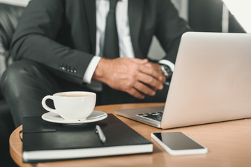 businessman with laptop and coffee on table