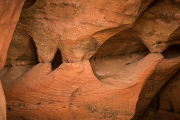 A beautiful closeup of a sandstone cliffs in Latvia. Close pattern of a sand formations. Sandstone caves at the seaside. Colorful photo of sandstone