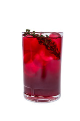A red cocktail isolated in a highball with lots of ice cubes and rosemary as a decoration.