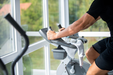man riding exercise bike