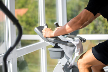 man in sportswear running on treadmill at gym