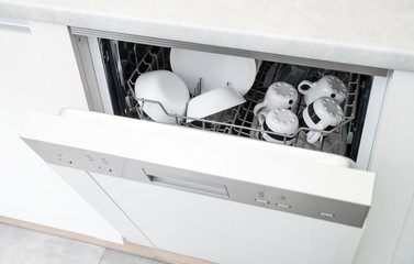 Open dishwasher with clean dishes