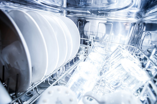 Interior of dishwasher machine with clean dishes