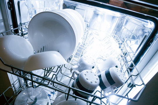 Interior of dishwasher machine with clean dishes