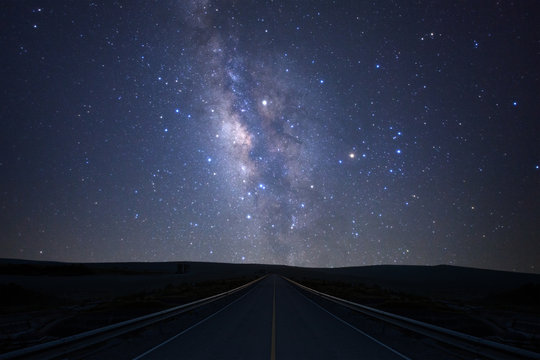 Fototapeta The milky way galaxy over the road with stars and space dust in the universe