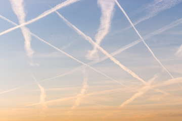 Fototapeta na wymiar plane trails in the sky sunset