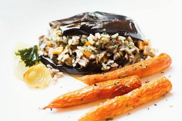 Baked aubergine stuffed with rice, carrot and onion.