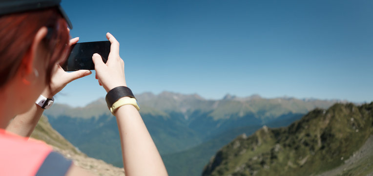 Photo of tourist woman photographing mountain