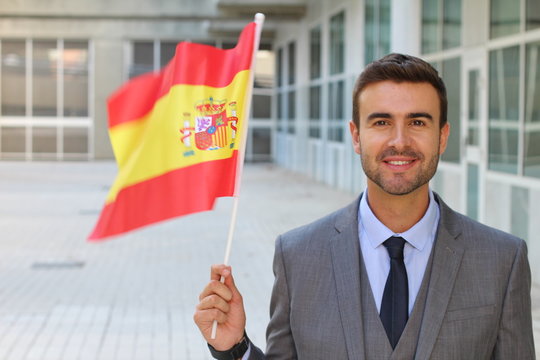 Male proudly waving the Spanish flag