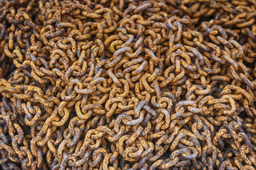 Mountain of rusty iron chain. Orange background