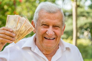 elderly showing euros