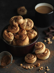 Delicious fresh homemade puff pastry with cinnamon on the wooden table, rustic style