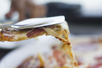 eating pizza in a cafe with white plates. People eat fast food in cafe.