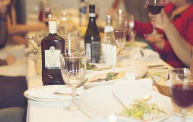 Served dishes to the table for holiday. Cutlery and food on white tablecloths in the restaurant. Design a festive Banquet. Luxurious food for guests and visitors.