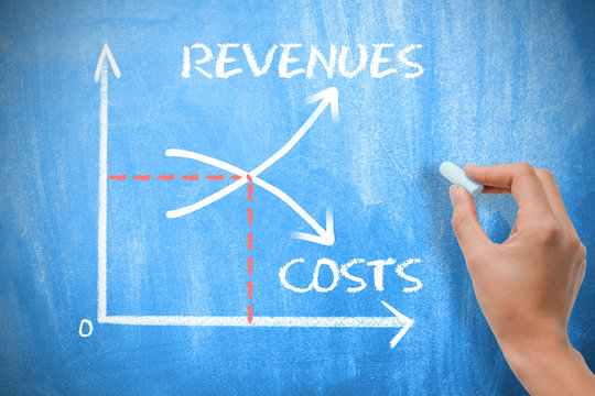 Profitability increase concept with businesswoman writing with a chalk on blue blackboard