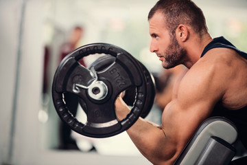 Fototapeta na wymiar Man lifting weights, training, gym