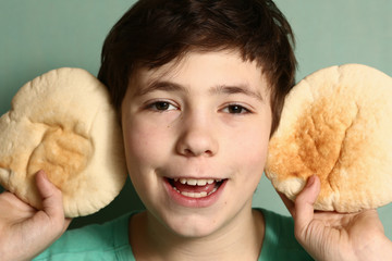 teenager boy make tortilla bread  ears clouse up smiling funny photo 