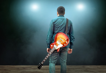 Artist Guitarist hands play on electricity guitar under light, P