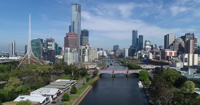 CBD of Melbourne city along Yarra river between South Yarra and downtown districts with modern high-rise towers and railway station.
