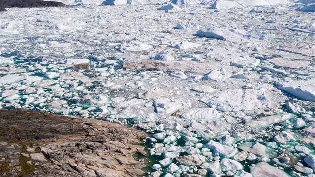 Arctic landscape nature with icebergs and ice in Greenland icefjord. Aerial drone footage video of ice and iceberg. Ilulissat Icefjord with icebergs from Jakobshavn Glacier aka Sermeq Kujalleq glacier