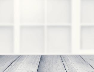 Gray table or shelf and blurred wall with windows
