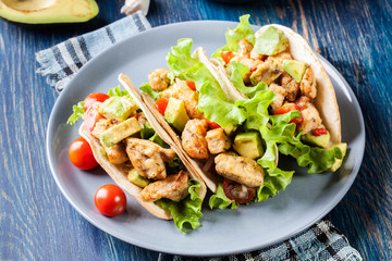 Authentic mexican tacos with chicken and salsa with avocado, tomatoes and chillies