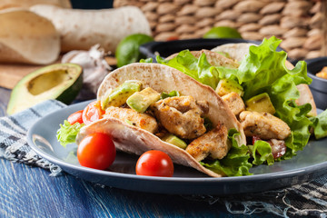 Authentic mexican tacos with chicken and salsa with avocado, tomatoes and chillies
