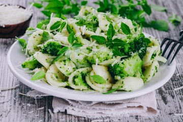 homemade pasta orecchiette with broccoli, Parmesan cheese and basil