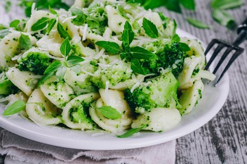 homemade pasta orecchiette with broccoli, Parmesan cheese and basil