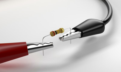 Testing resistor with red and black alligator clips which is connected the multimeter on isolated. 