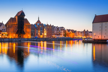 Fototapeta na wymiar Gdansk at night with historic port crane reflected in Motlawa river, Poland