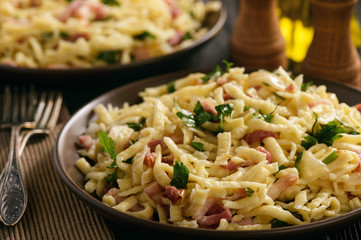 Spaetzle with bacon and onion, german style cuisine.