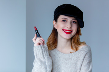 woman in sweater and hat with lipstick