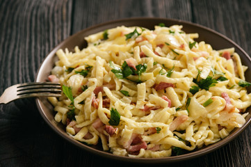 Spaetzle with bacon and onion, german style cuisine.