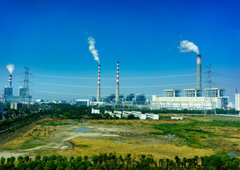  Smoking smokestack of chemical plant with blue sky