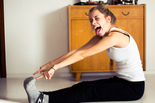 Young Woman Doing Gymnastics At Home