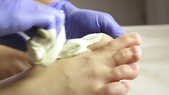 Legs epilation process with sugar mass. Master of shugaring at work