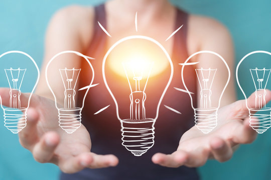 Businesswoman touching and holding a sketch lightbulb with a pen