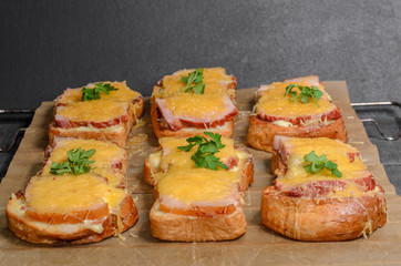 Six sandwiches with meat, cheese and greens top view