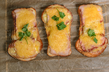 Six sandwiches with meat, cheese and greens top view