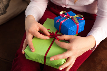 Closeup of female holding bright present boxes