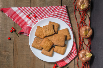 Biscuits, milk, red napkin, Christmas decor with free space for text. Top view