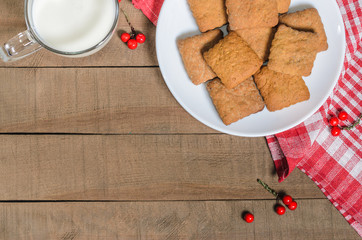 Biscuits, milk, red napkin, Christmas decor with free space for text.