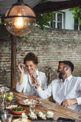 Couple Enjoying Wine and Food at Restaurant