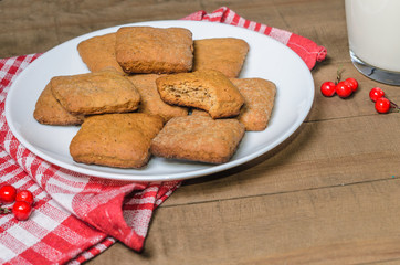 Biscuits, milk, red napkin, Christmas decor with free space for text.